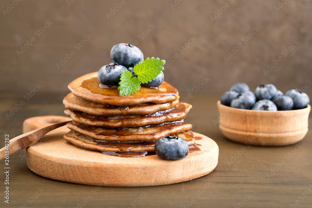 Chocolate pancakes with blueberries on a dark background. Chocolate pancakes with blueberries on a dark background.