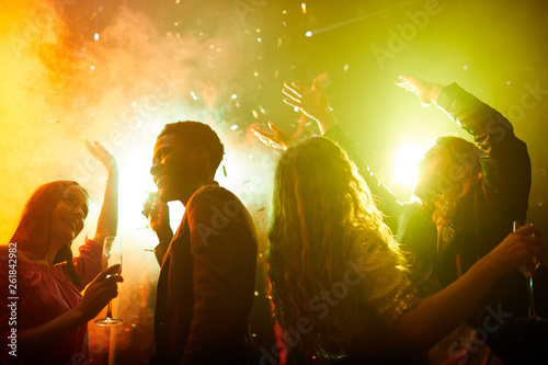 Photography Crowd of free and happy young multiethnic people drinking champagne and dancing