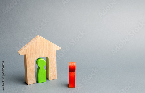 A wooden figure of a man meets a guest. The concept of an apartment house, real estate. Buying and selling apartments, affordable housing for families. Protection photo