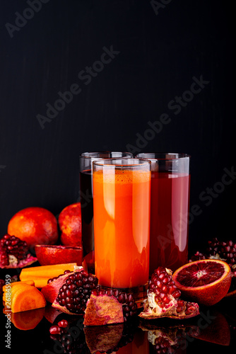 Set of healthy fresh drinks on the black background. Raw drinks and foods.