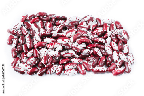 Pile of ripe speckled kidney Anasazi beans, with vivid burgundy color isolated on white background. Close-up. photo