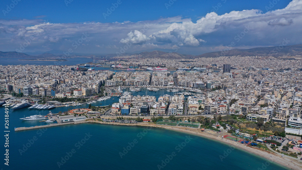 Fototapeta premium Aerial drone bird's eye view panoramic photo of iconic round shaped picturesque port of Mikrolimano with sail boats and yachts docked and beautiful clouds, Piraeus port, Attica, Greece