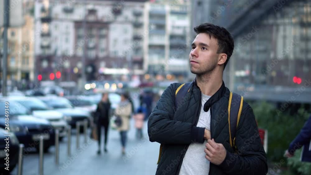 Young Attractive Man Walking on Street and Using Smartphone Young Attractive Man Walking on Street and Using Smartphone