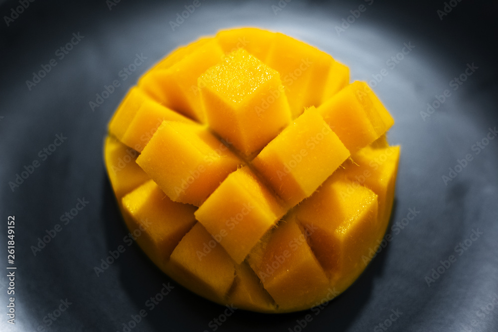 Close-up of mango fruit on black background.