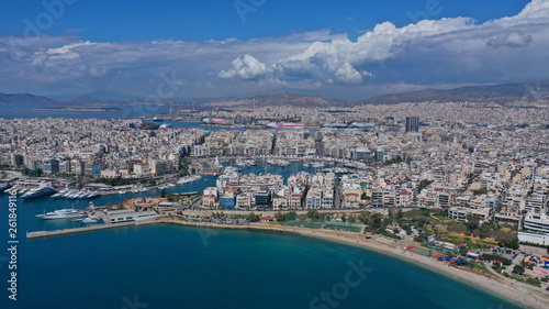 Aerial drone bird's eye view panoramic photo of iconic round shaped picturesque port of Mikrolimano with sail boats and yachts docked and beautiful clouds, Piraeus port, Attica, Greece © aerial-drone