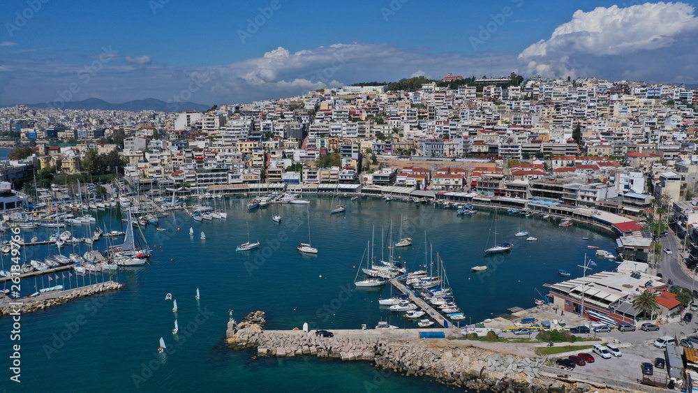 Aerial drone bird's eye view panoramic photo of iconic round shaped picturesque port of Mikrolimano with sail boats and yachts docked and beautiful clouds, Piraeus port, Attica, Greece Aerial drone bird's eye view panoramic photo of iconic round shaped picturesque port of Mikrolimano with sail boats and yachts docked and beautiful clouds, Piraeus port, Attica, Greece