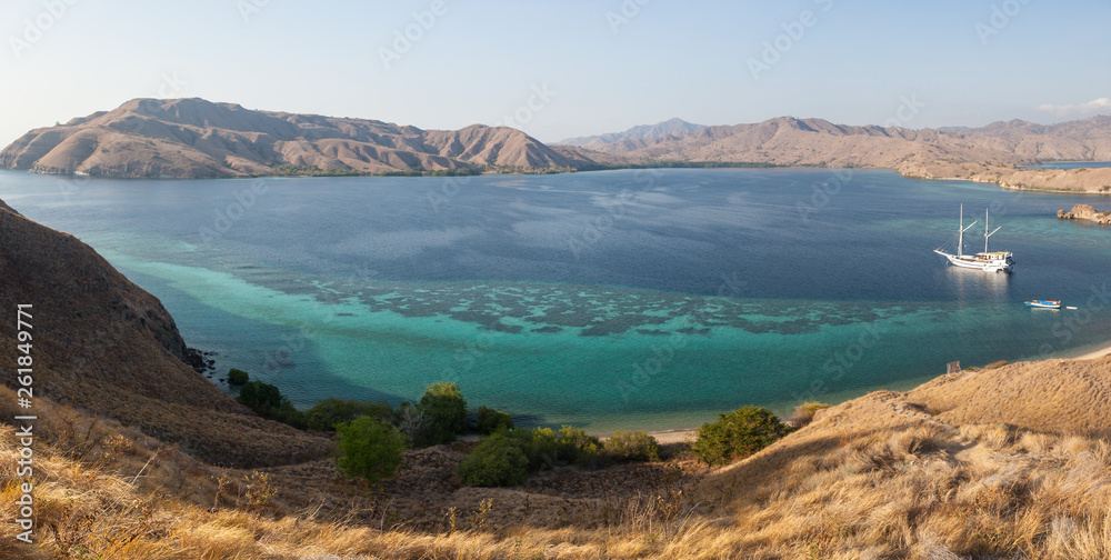 Dry grasses cover many of the islands in Komodo National Park, Indonesia. This region is known for its beautiful marine biodiversity.