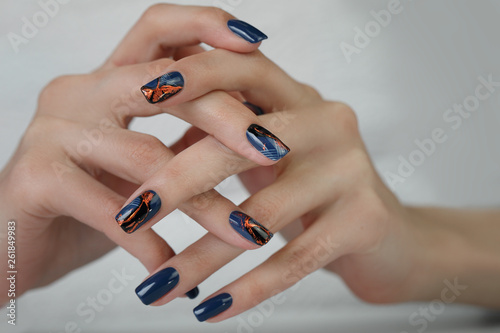 The female hand with dark blue glittered nails. Hand of the girl. Female manicure. nail art manicure.