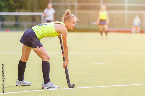 Young professional hockey player with stick on the field
