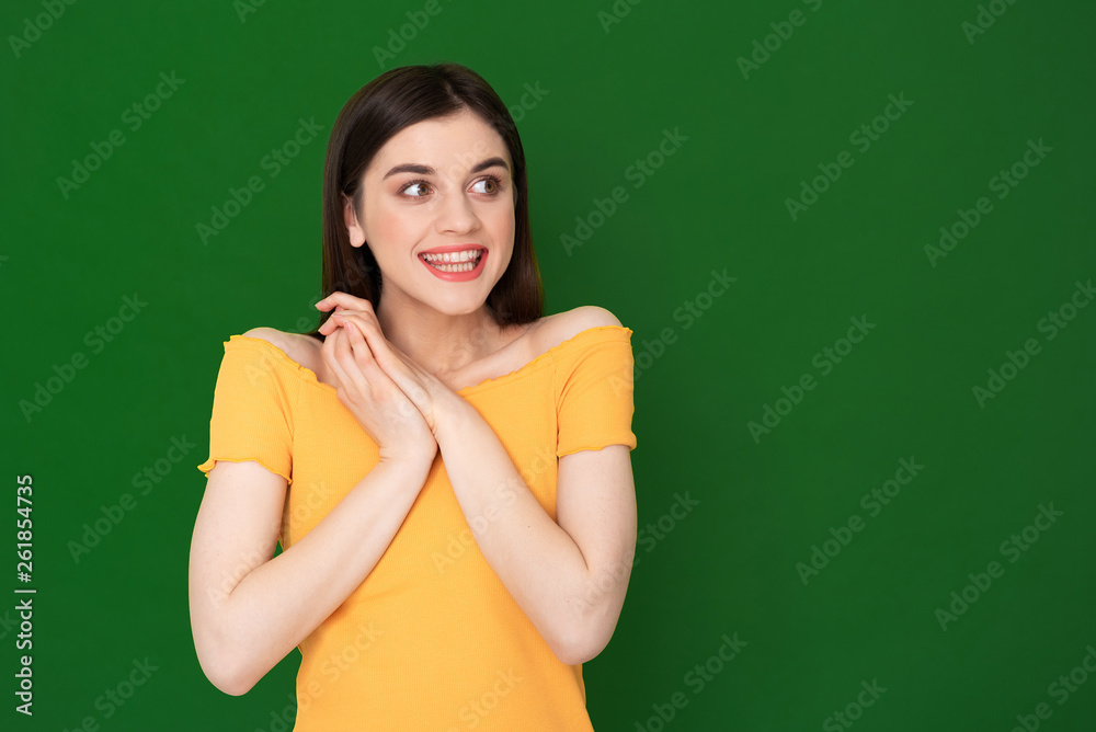 Expressive happy young girl isolated on green Expressive happy young girl isolated on green