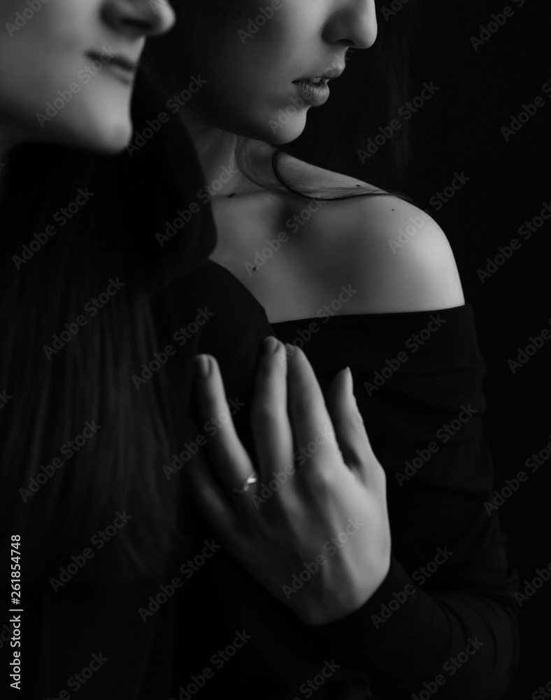 fashion black and white photo of two beautiful girls with dark hair