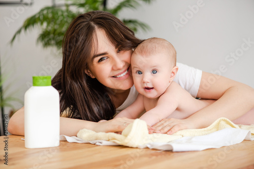 Portrait of mother and infant with lotion