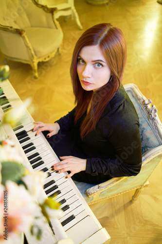 pianist girl playing a musical instrument piano