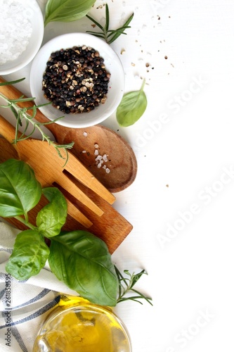 Wooden spoon, fork and ingredients on white background. Vegetarian and vegan food. Healthy cooking concept. Top view with copy space.