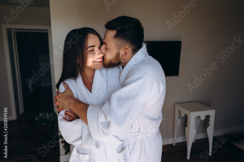 Happy couple enjoy each other's company in a hotel room.