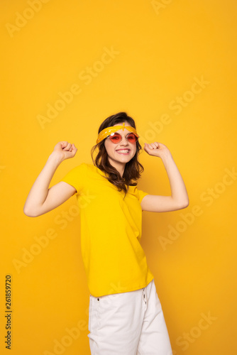 Happy smiling hipster girl holding hands up