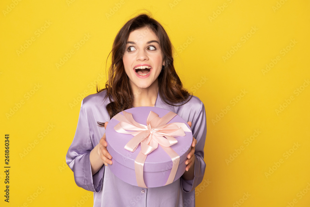 Happy excited girl holding festive present box Happy excited girl holding festive present box