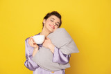 Dreamful girl with cup of coffee and pillow