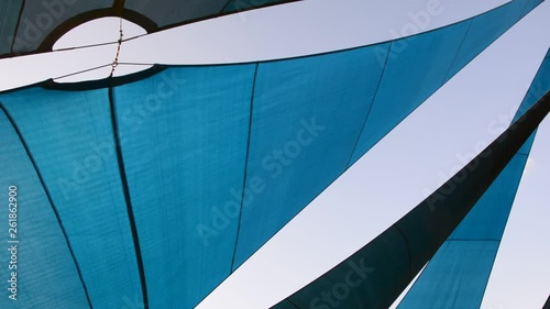 Sunshade shelter at dusk. blue awning canopy in the wind