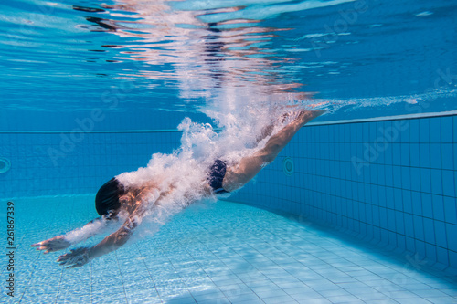 Boy dive in swimming pool