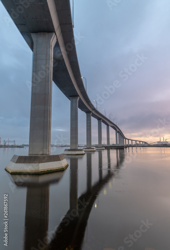 The massive Jordan Bridge over the Elizabeth River in Virginia, reflecting in the water at sunset, in high resolution photo