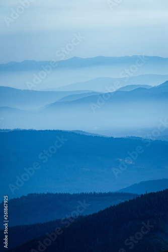 Fototapeta Naklejka Na Ścianę i Meble -  Smoke filled mountain layers in summer due to wildfires