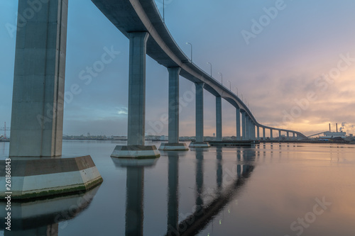 The massive Jordan Bridge over the Elizabeth River in Virginia, reflecting in the water at sunset, in high resolution photo