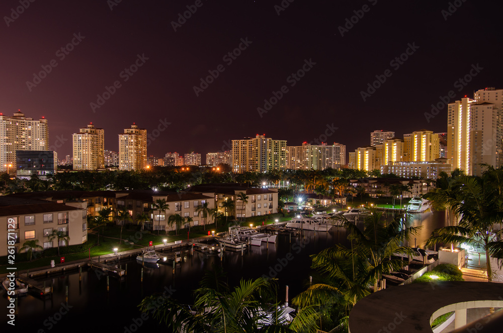 Miami Florida skyline at night with sailboats, yachts, and condos