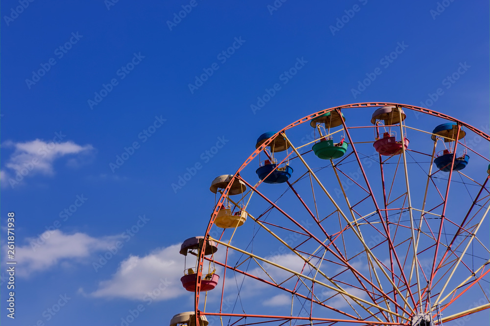 Ferris wheel in the park against blue sky. Ferris wheel in the park against blue sky.
