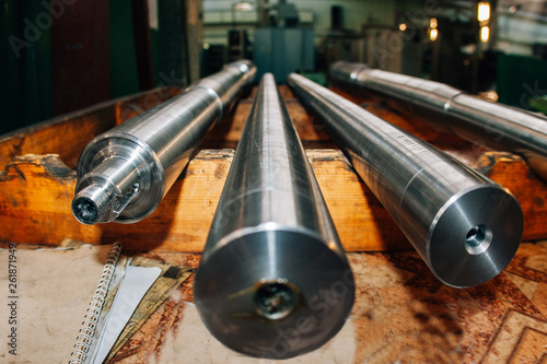New steel shafts in factory, close up, selective focus