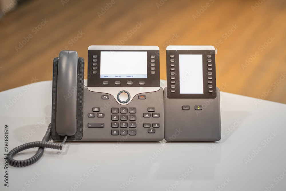 IP Phone device put on desk office and blur background wood floor IP Phone device put on desk office and blur background wood floor