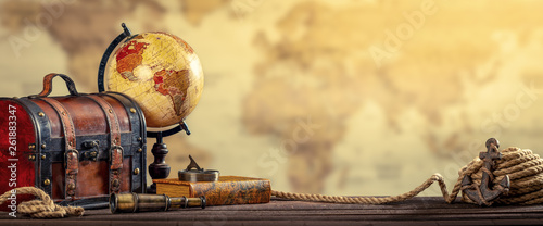Vintage World Globe, Suitcase, Compass, Telescope, Book, Rope And Anchor With Map Background And Aged Yellowed Effect - Travel Concept photo
