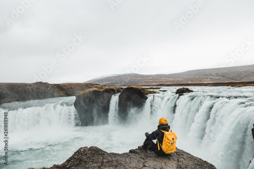 woman looking at picturesque Godafoss waterfall, Iceland. Nordic nature