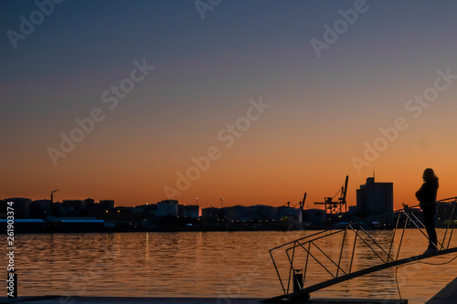 Stockholm, Sweden A woman admires the sunset over the harbour.