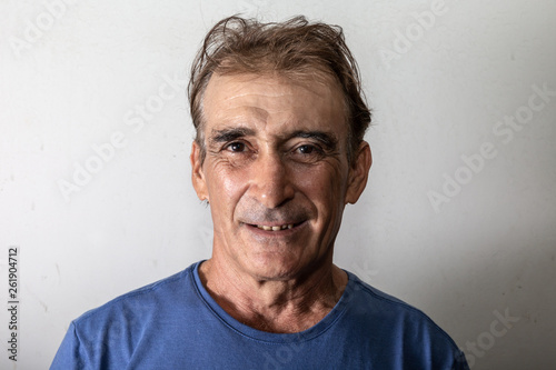 Older man laughing on white background.