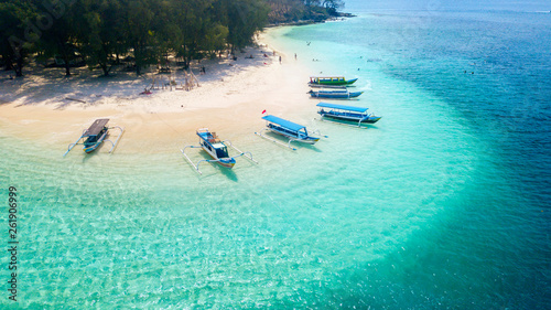 Wooden boats anchored on the Gili Rengit beach photo