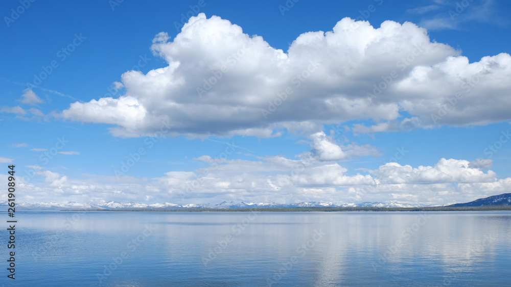 reflection of lake and cloudy blue sky