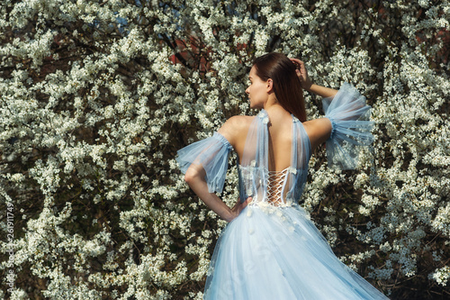 Wallpaper Mural Portrait of a young beautiful fashionable woman in an evening dress . Girl posing in a blooming garden Torontodigital.ca