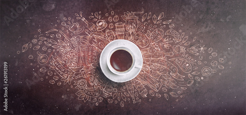 Coffee chalk illustrated concept on black board background - white coffee cup, top view with chalk doodle illustration about coffee, beans, morning, espresso in cafe, breakfast. Morning coffee