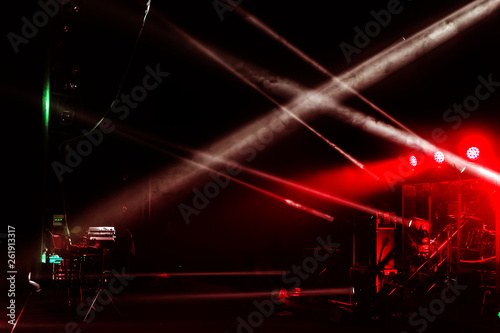 Stage lights. Several projectors in the dark. Multi-colored light beams from the stage spotlights on the stage in the smoke at the time of the entertainment show. Night club. Lights show. Lazer show © Aleksandr Lesik