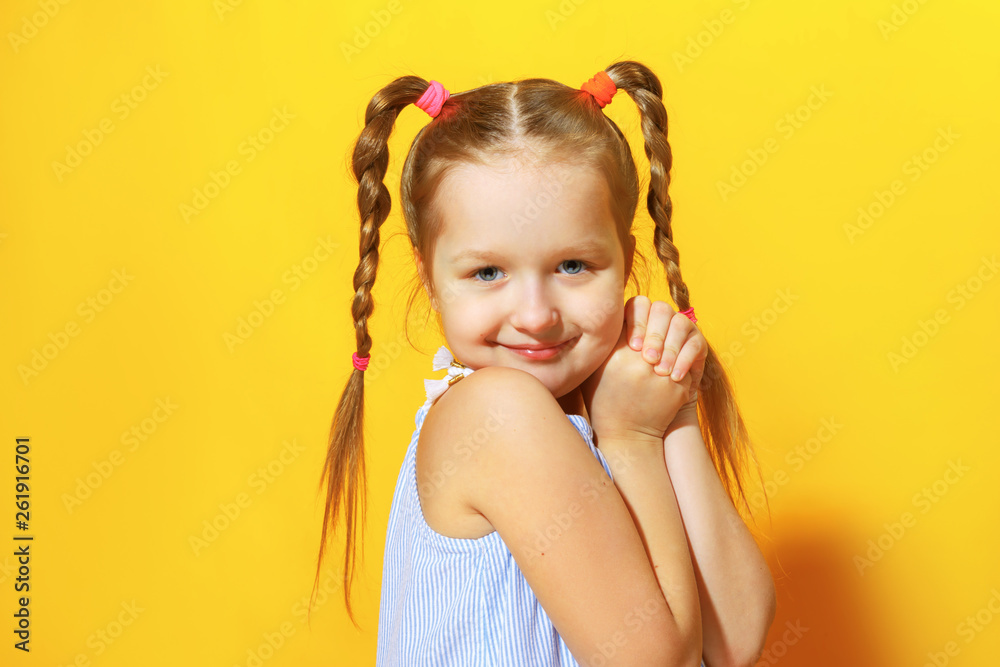 Closeup portrait of charming cute little child girl on yellow background. Closeup portrait of charming cute little child girl on yellow background.