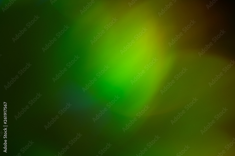 Obraz premium Blurred green and yellow lights. Bokeh abstract background with lens flare glow effect.