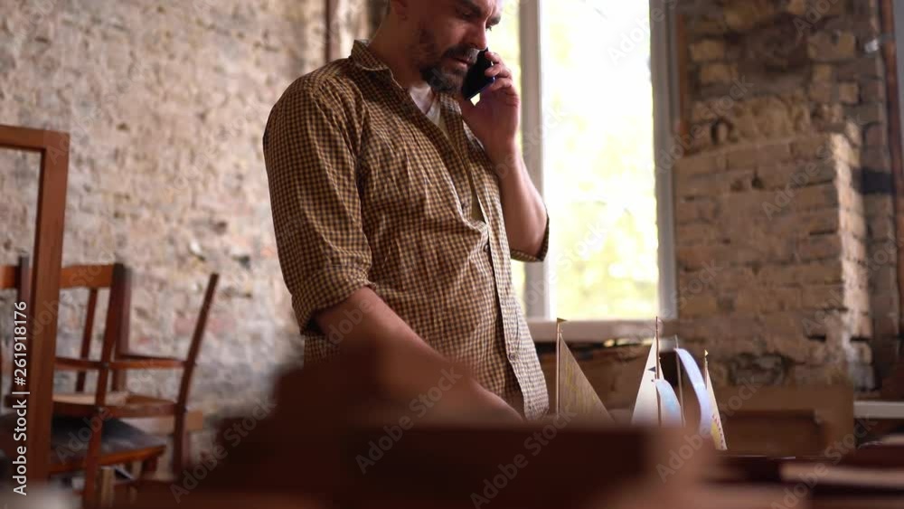 Carpenter holding small ship figure Carpenter holding small ship figure