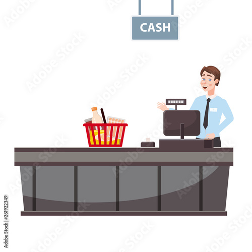 Cashier behind the cashier counter in the supermarket, shop, store with a basket full of groceries