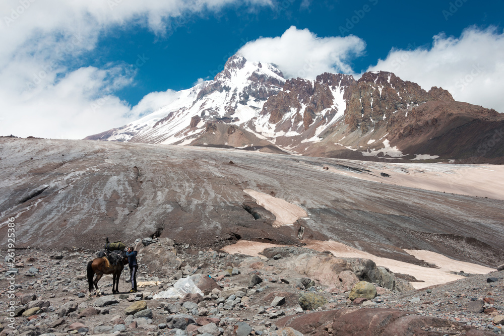 Kazbegi, Georgia - Jun 29 2018: Mount Kazbek (5047m) at Gergeti Glacier. a famous landscape in Kazbegi, Mtskheta-Mtianeti, Georgia.
