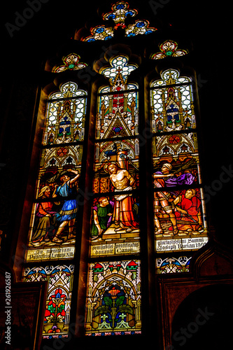 Stained glass window in the temple. The background around the glass is dark