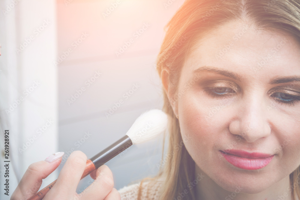 Beautiful blonde hair woman applying makeup, fashion and beauty concept Beautiful blonde hair woman applying makeup, fashion and beauty concept