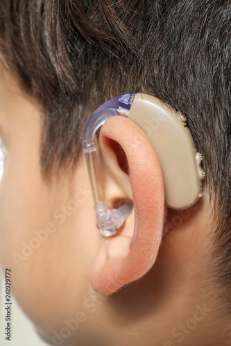 Little boy with hearing aid...