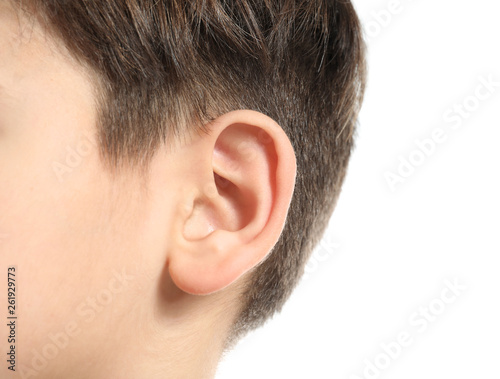 Little boy with hearing problem on white background, closeup