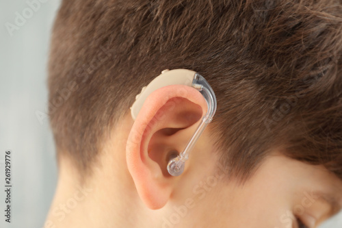 Little boy with hearing aid...